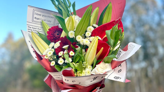 Elegant flower bouquet with lilies, roses, chrysanthemums & fillers wrapped in vibrant paper—perfect for any occasion. Shop fresh flowers in Bangalore today!