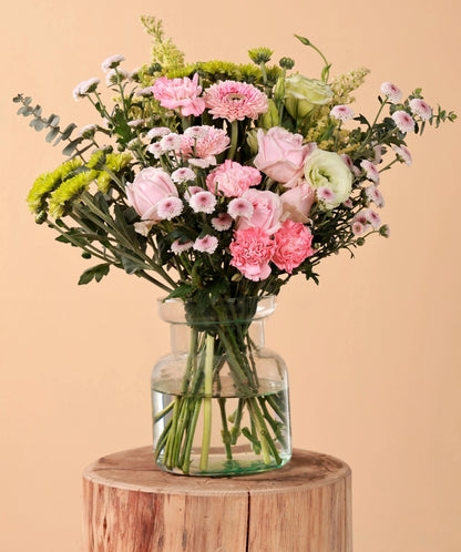 Bouquet of Sweet Avalanche roses, pink carnations, green chrysanthemums, eustoma, calimero, and pink gerberas in a glass vase